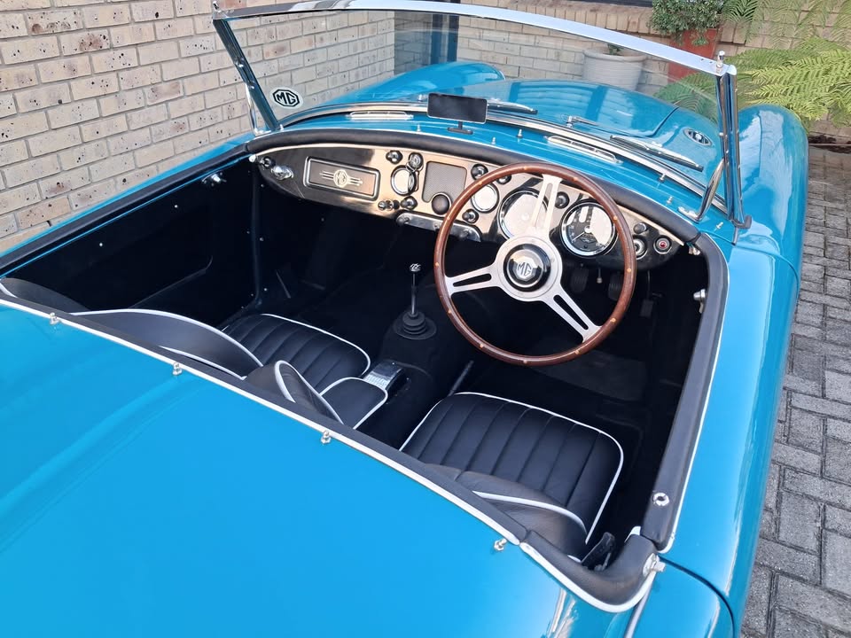 Black interior with white piping, wood-rimmed steering wheel